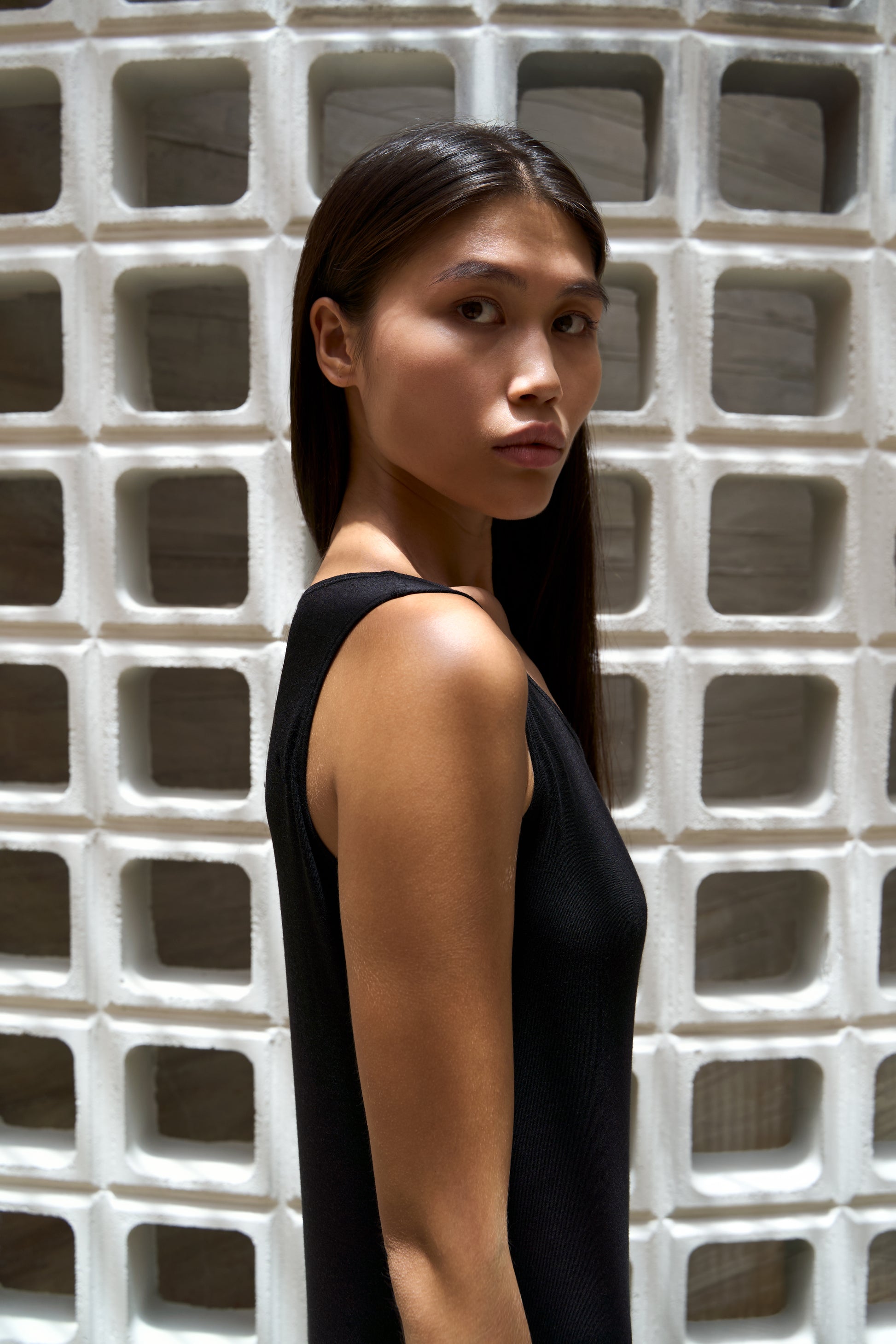Flip Tank Dress Black - side profile, white wall
