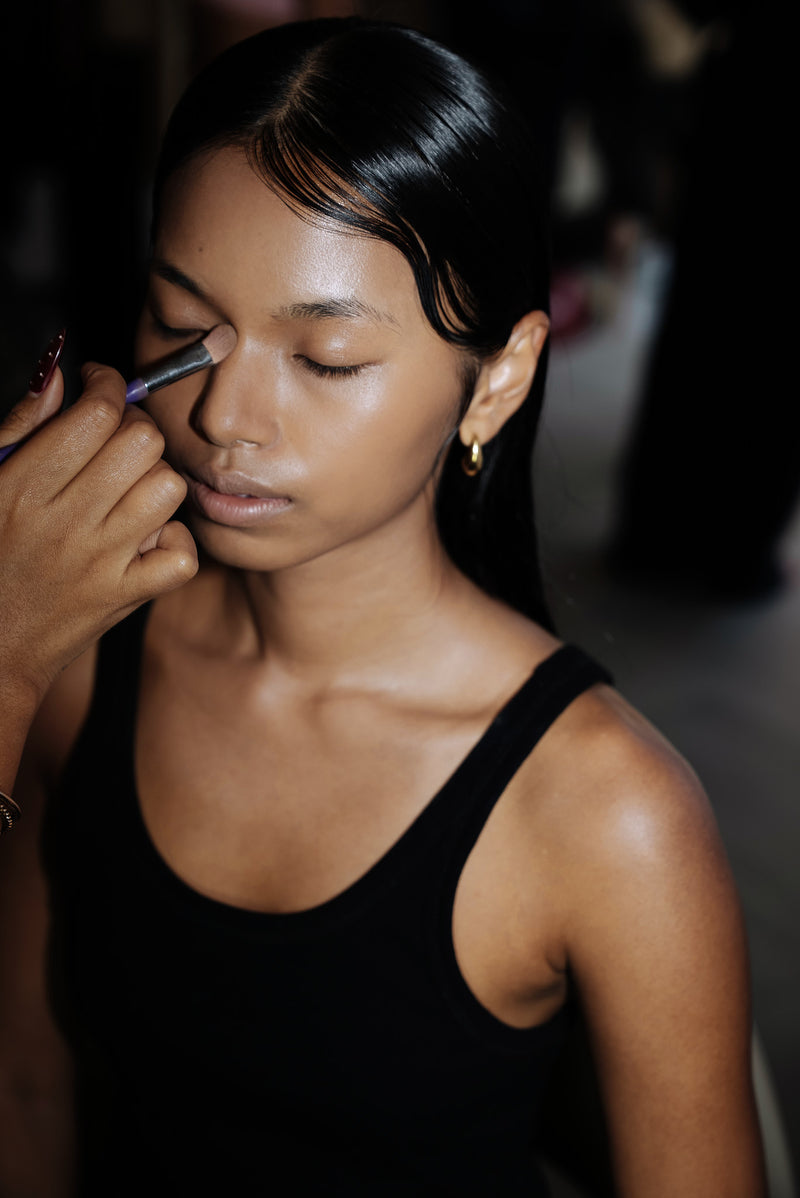 Final makeup preparation before the runway.